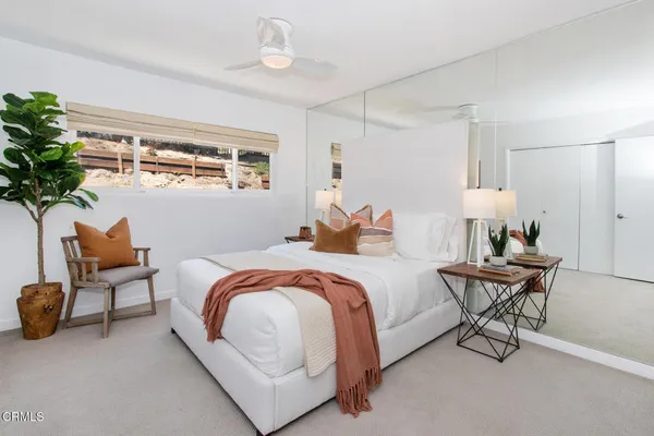 a bed room with a bed and a chair