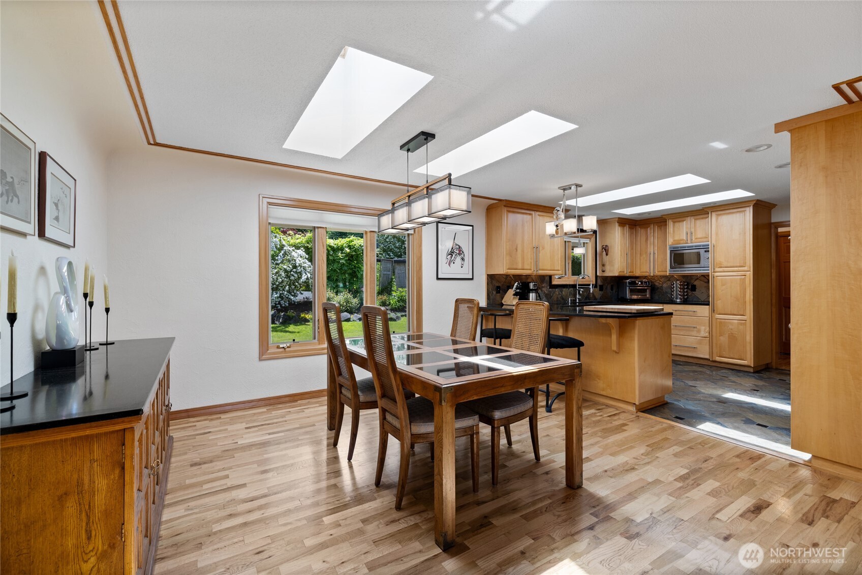 295 Southeast Bayview Road Shelton, WA 98584 - Photo 11 of 40 a kitchen with stainless steel appliances kitchen island granite countertop a table chairs and a refrigerator