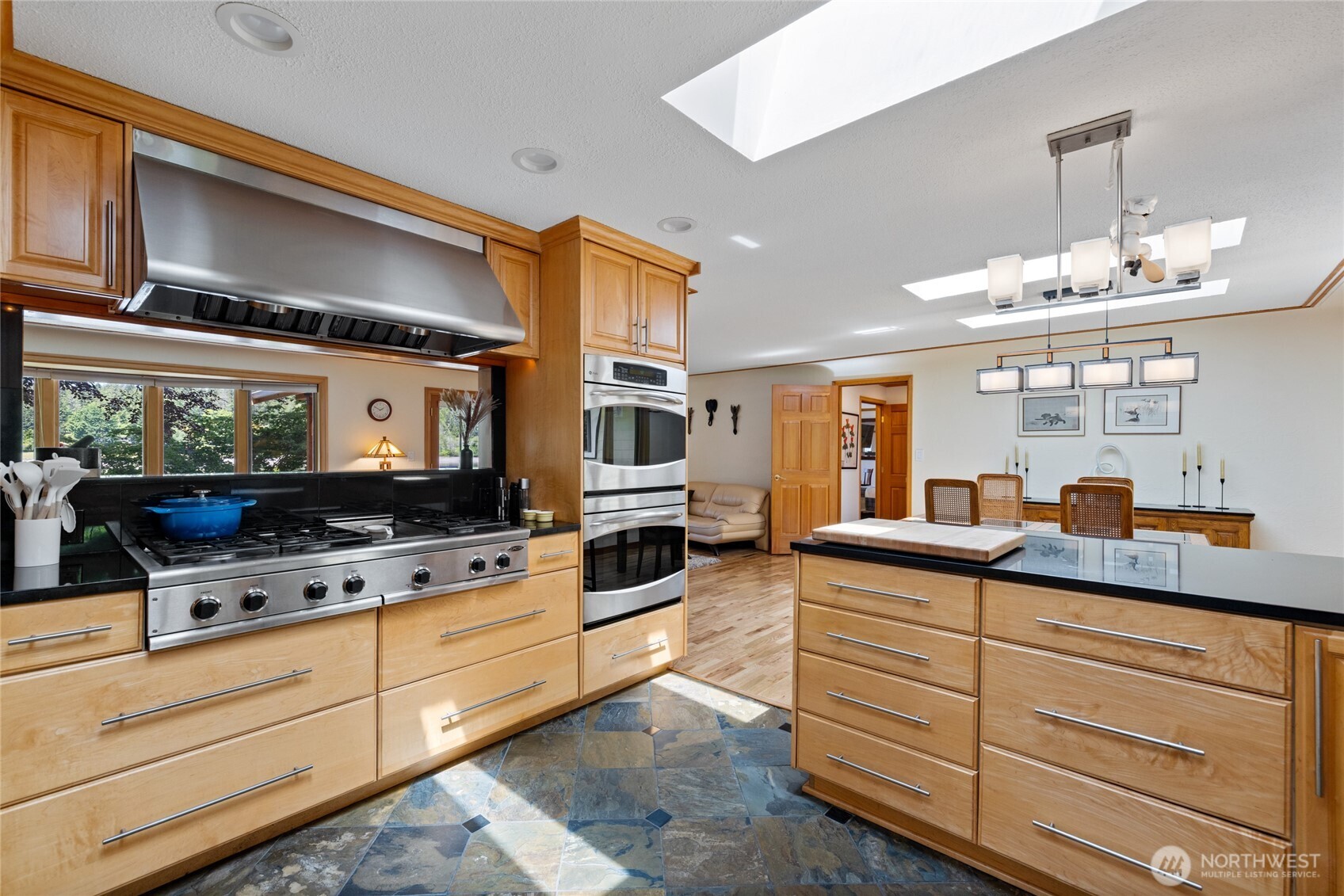 295 Southeast Bayview Road Shelton, WA 98584 - Photo 15 of 40 a kitchen with granite countertop kitchen island white cabinets and stainless steel appliances