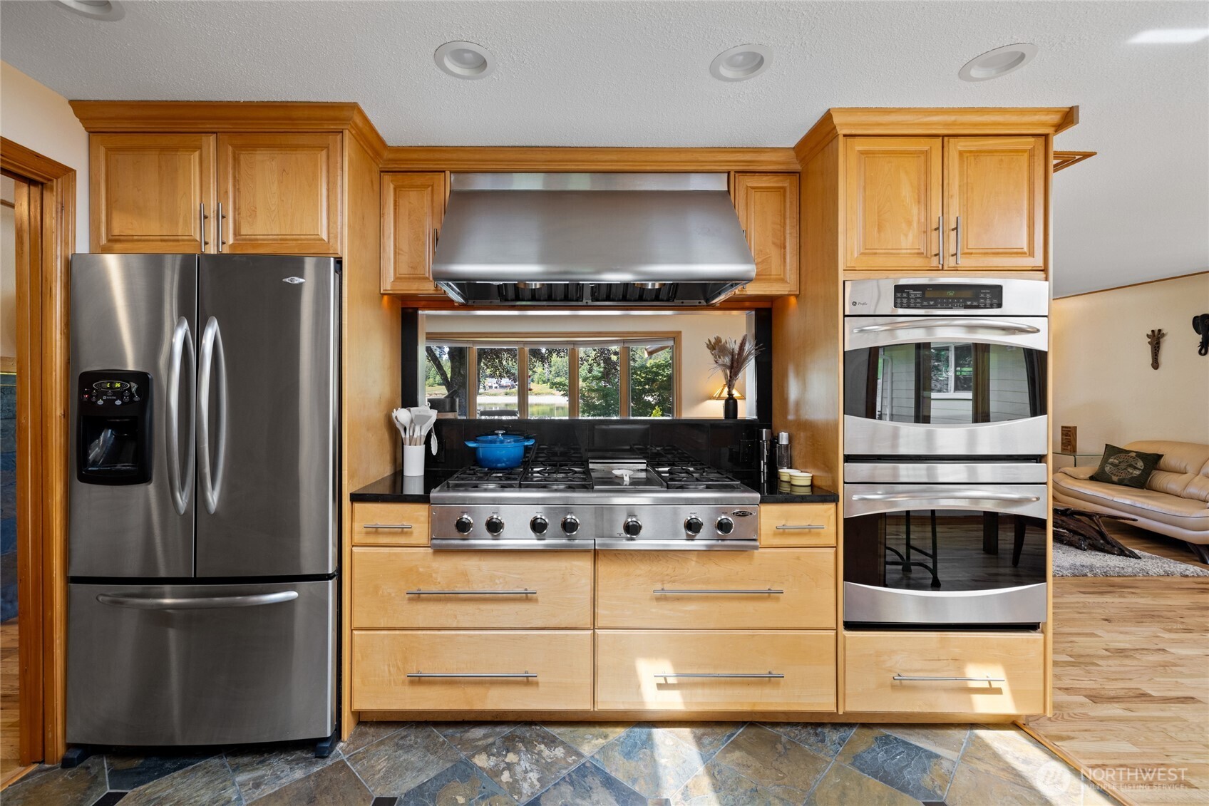 295 Southeast Bayview Road Shelton, WA 98584 - Photo 16 of 40 a kitchen with stainless steel appliances granite countertop a refrigerator stove and microwave