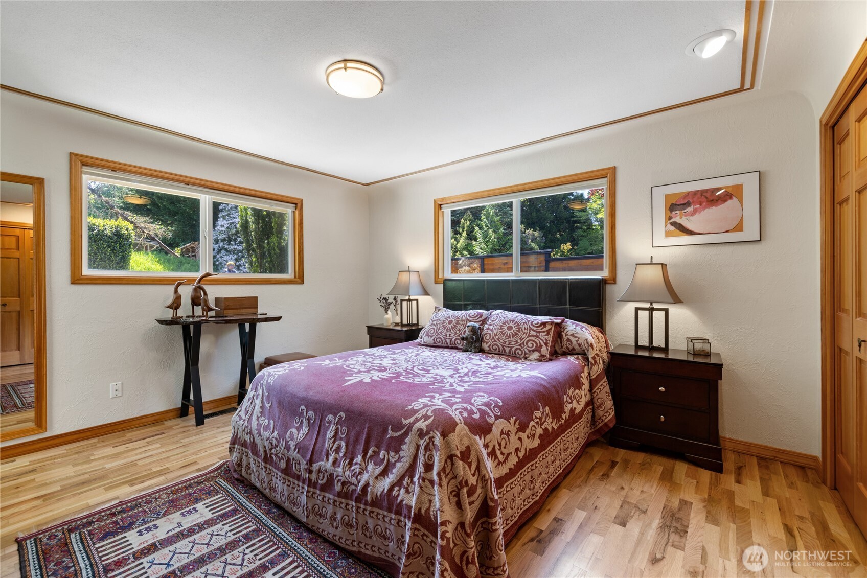 295 Southeast Bayview Road Shelton, WA 98584 - Photo 23 of 40 a bedroom with a bed and wooden floor