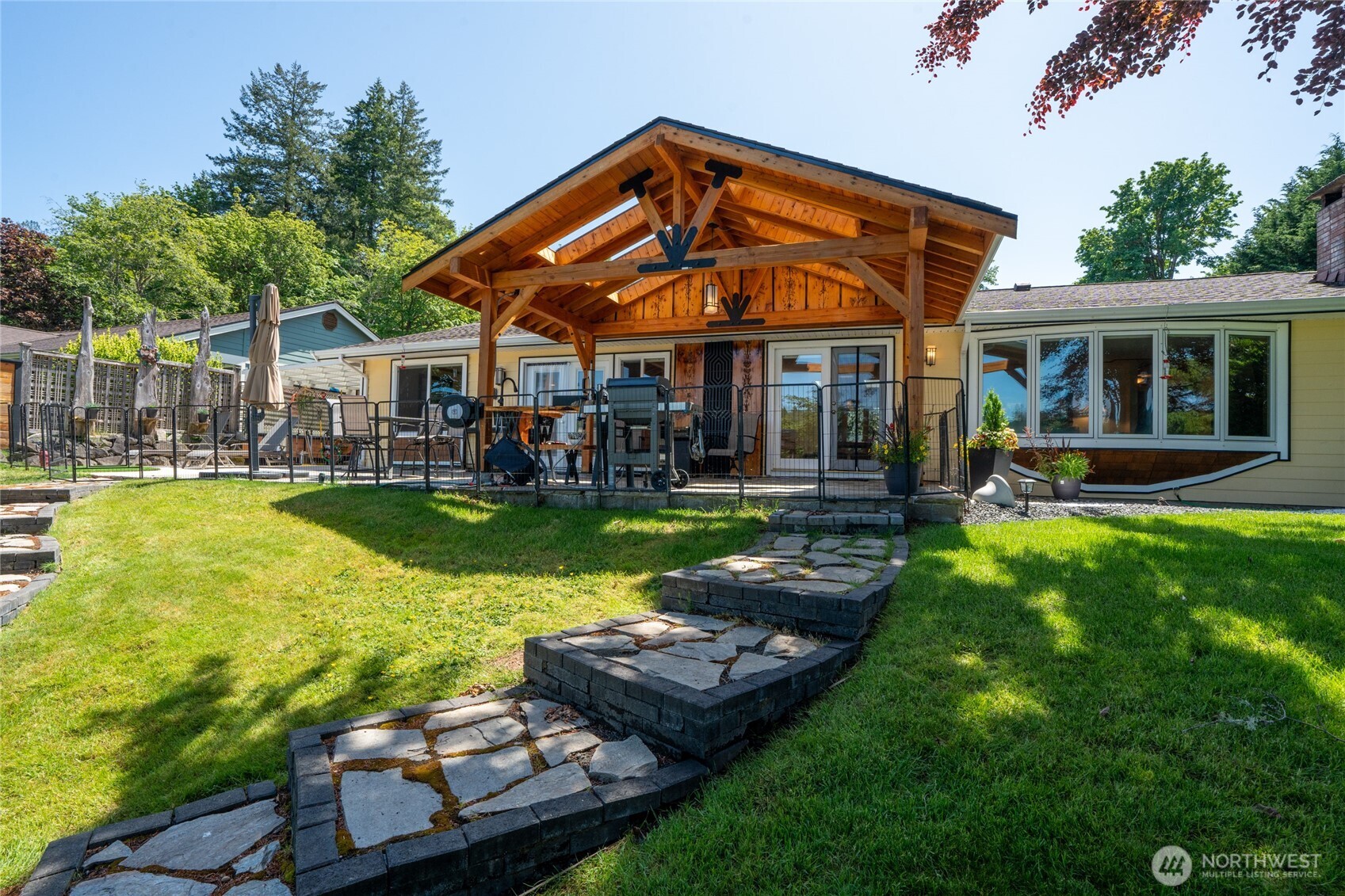 295 Southeast Bayview Road Shelton, WA 98584 - Photo 29 of 40 a front view of a house with swimming pool having outdoor seating