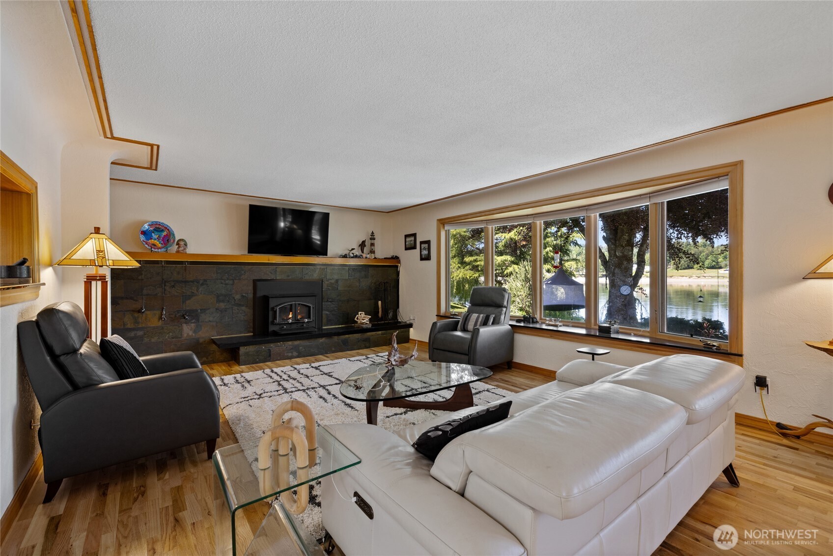 295 Southeast Bayview Road Shelton, WA 98584 - Photo 8 of 40 a living room with furniture and a fireplace