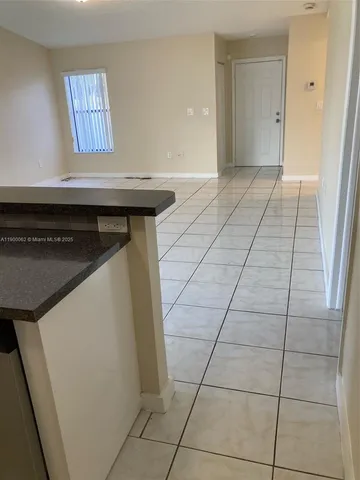 a view of an empty room and wooden floor