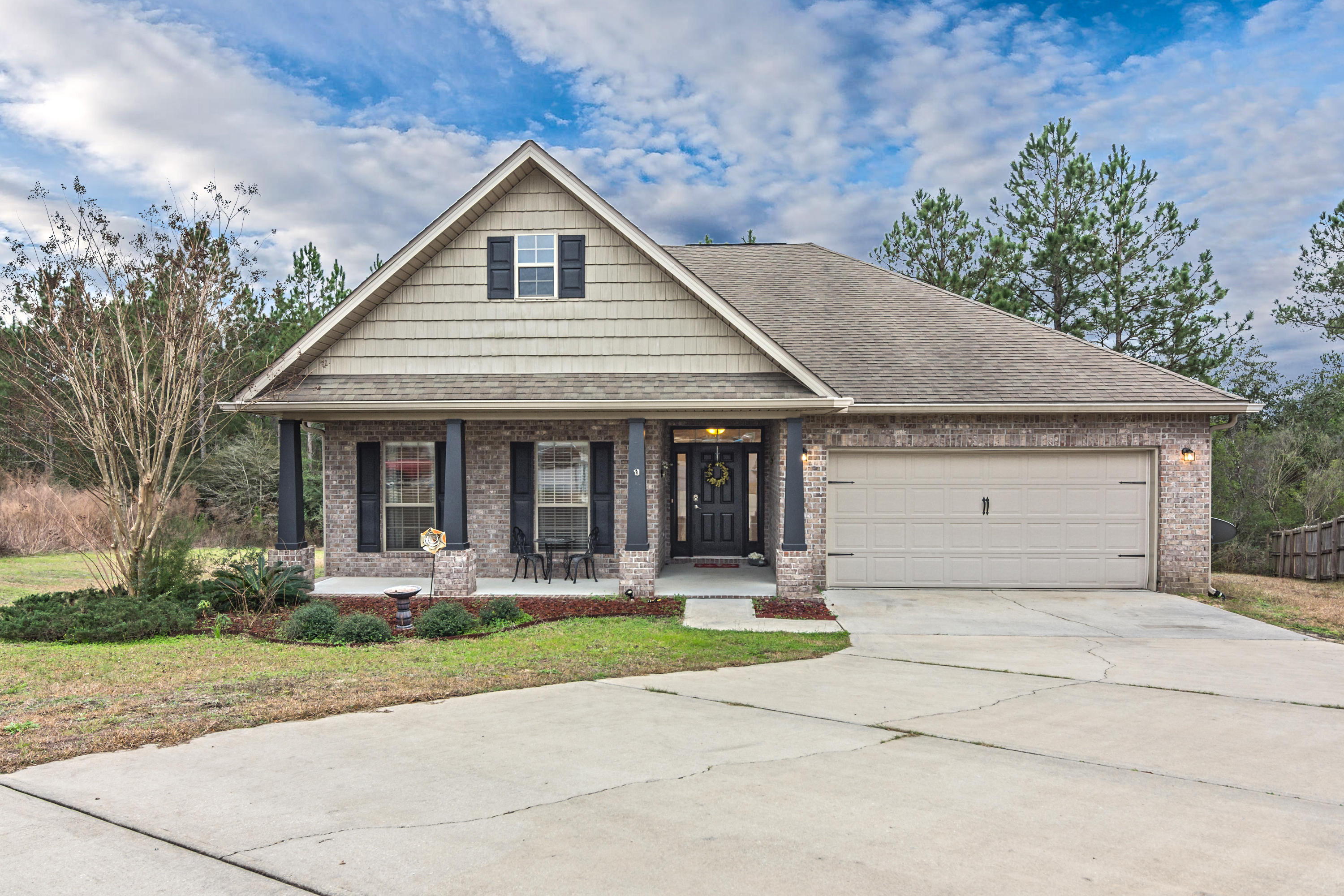 809 Yew Circle Crestview, FL 32536 - Photo 1 of 24 a front view of a house with garden
