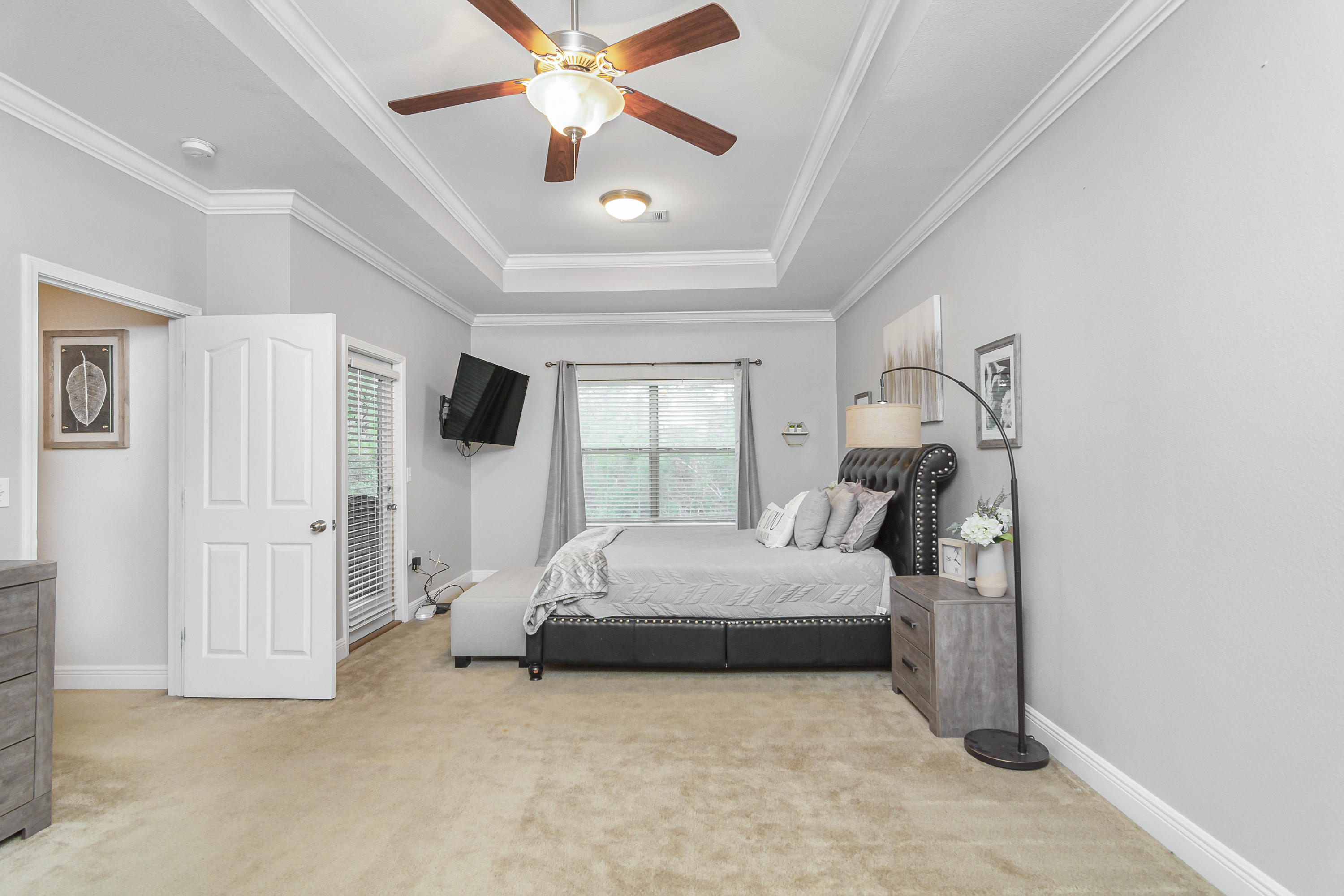 809 Yew Circle Crestview, FL 32536 - Photo 13 of 24 a bedroom with a bed and a flat tv screen