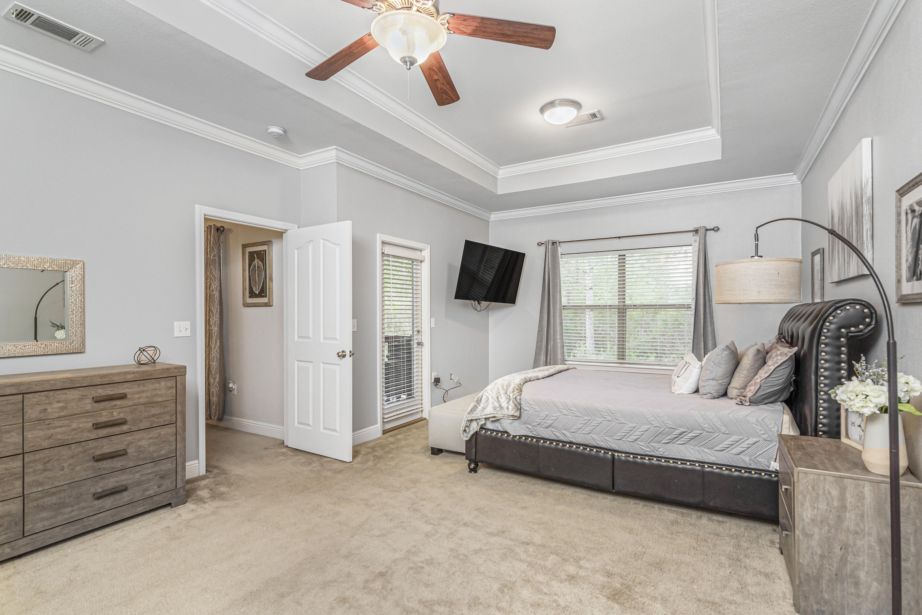 809 Yew Circle Crestview, FL 32536 - Photo 15 of 24 a bedroom with a bed and a flat screen tv