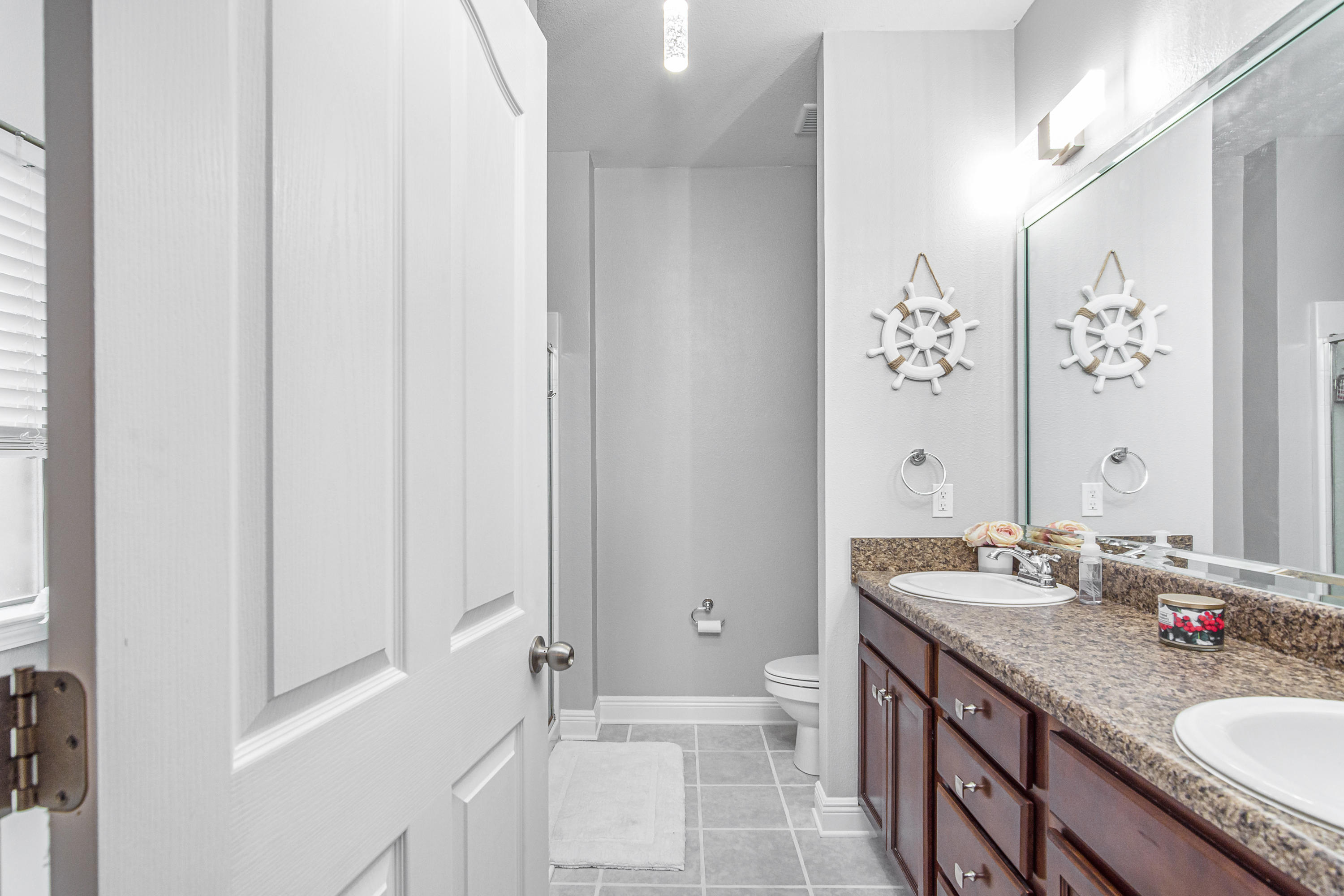 809 Yew Circle Crestview, FL 32536 - Photo 16 of 24 a bathroom with a granite countertop sink a mirror and a shower