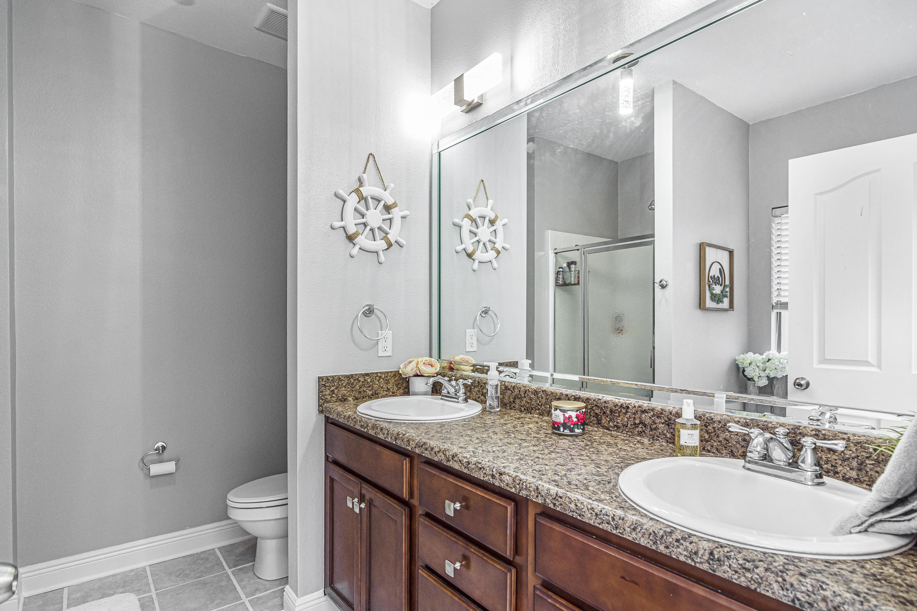 809 Yew Circle Crestview, FL 32536 - Photo 17 of 24 a bathroom with a granite countertop sink a toilet a mirror and shower