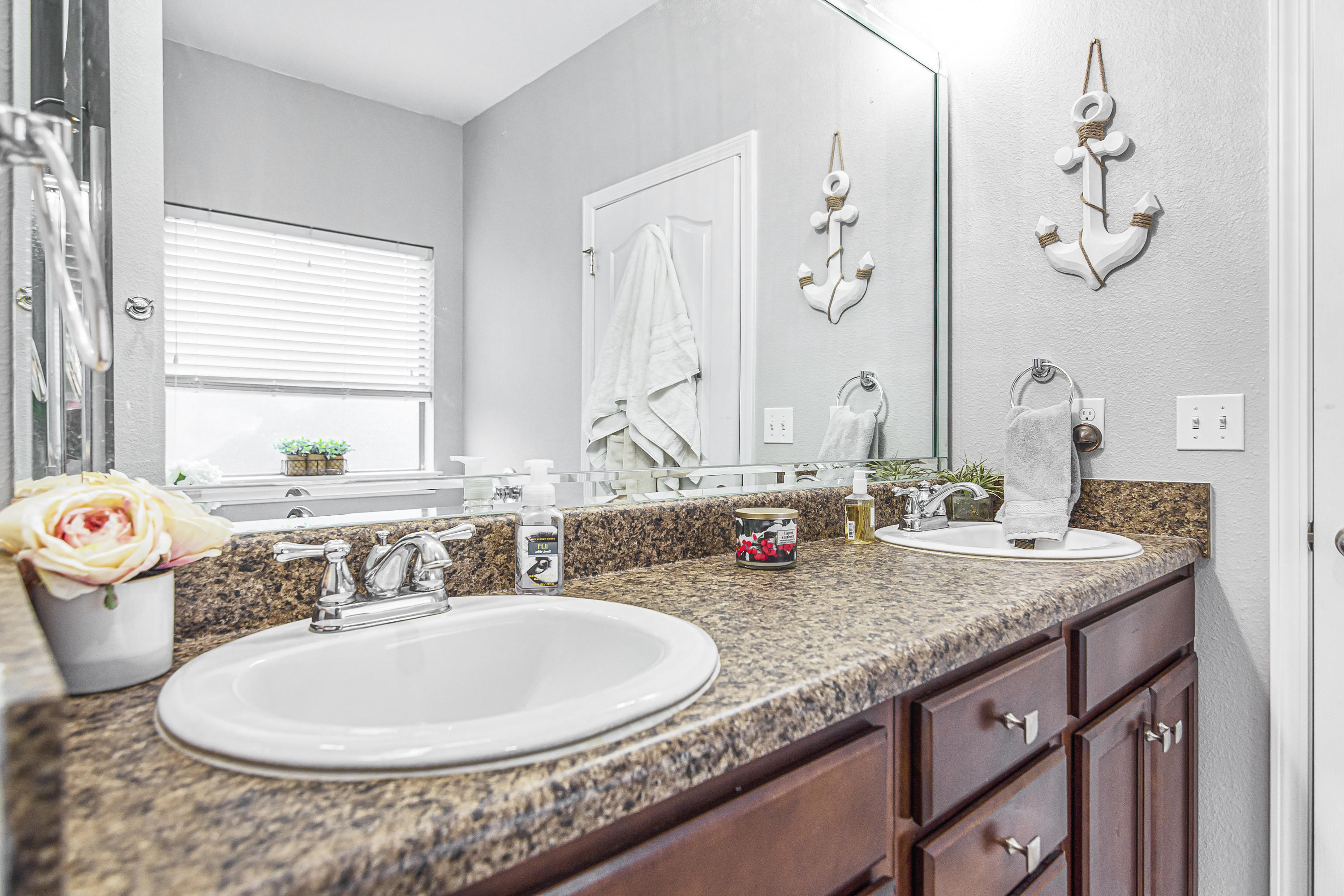 809 Yew Circle Crestview, FL 32536 - Photo 18 of 24 a bathroom with a granite countertop sink and a mirror