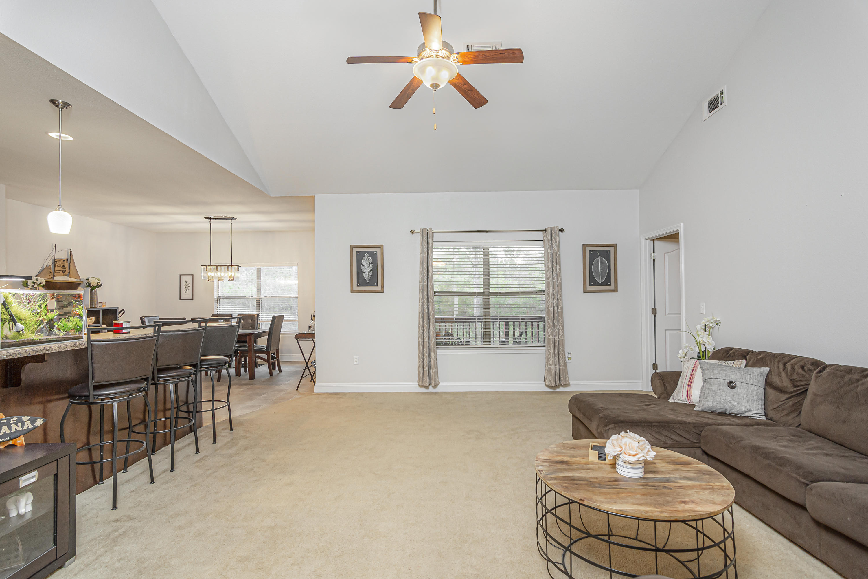 809 Yew Circle Crestview, FL 32536 - Photo 4 of 24 a living room with furniture a dining table and a chandelier