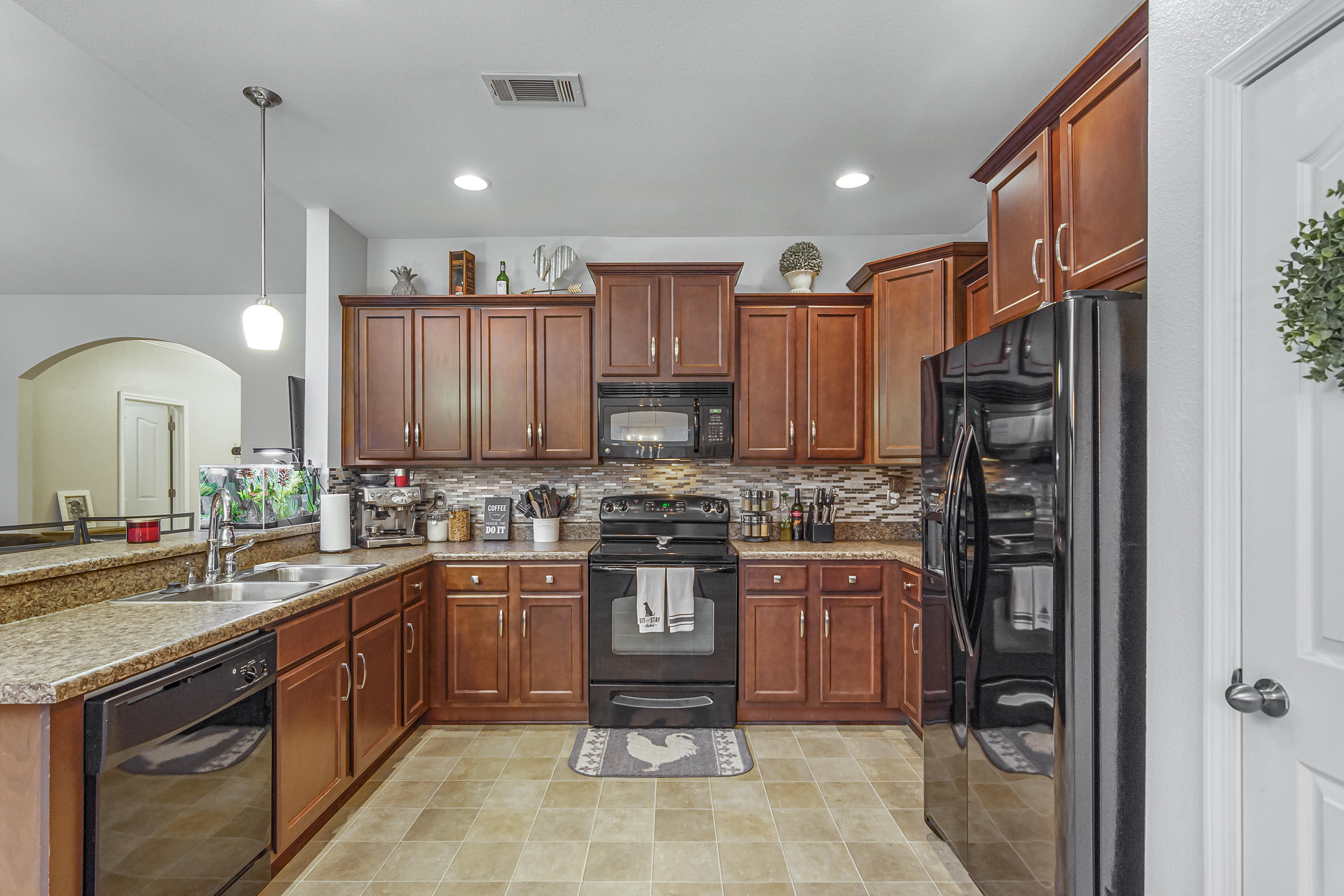 809 Yew Circle Crestview, FL 32536 - Photo 7 of 24 a kitchen with stainless steel appliances granite countertop a stove refrigerator and sink