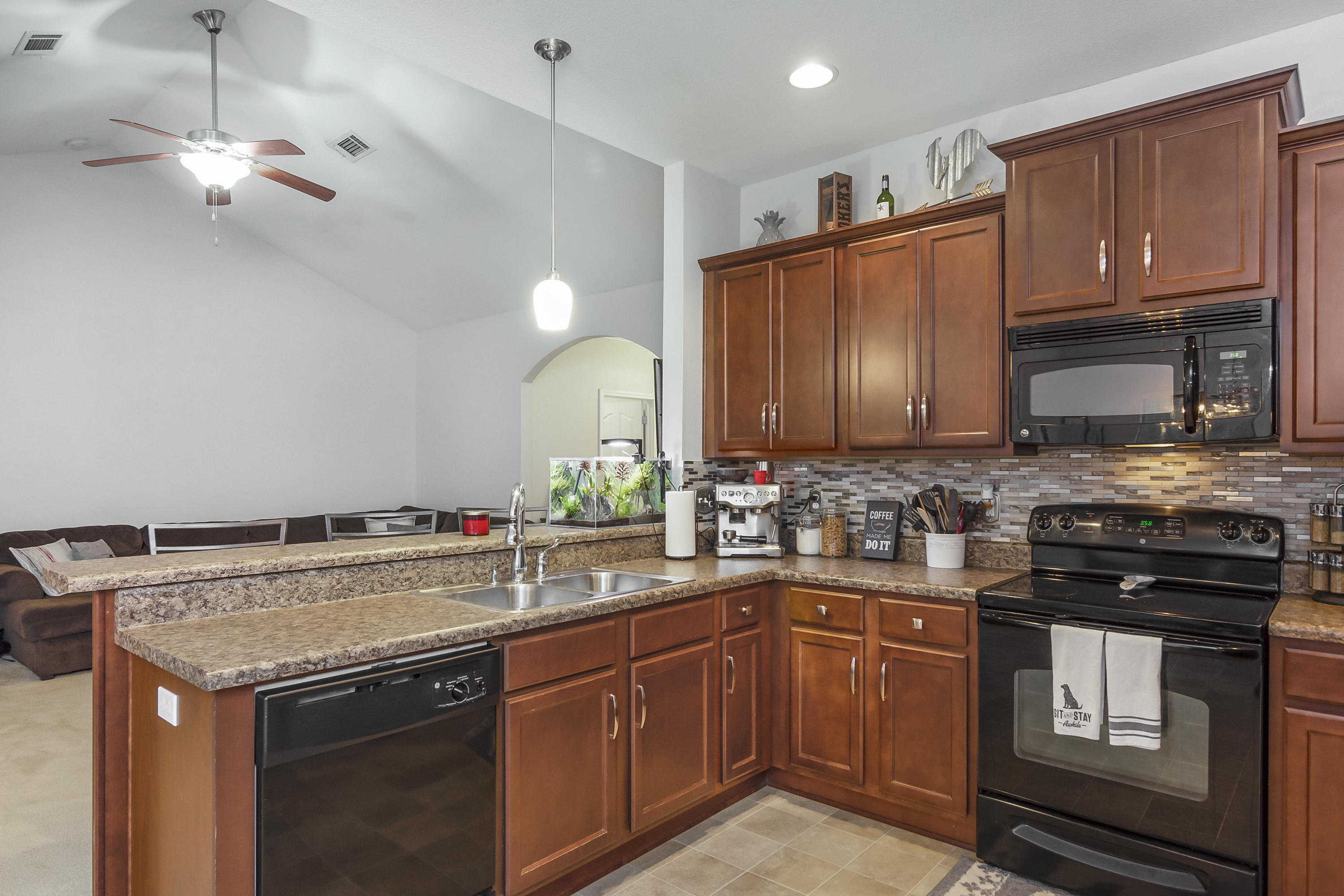 809 Yew Circle Crestview, FL 32536 - Photo 8 of 24 a kitchen with a sink a stove and cabinets