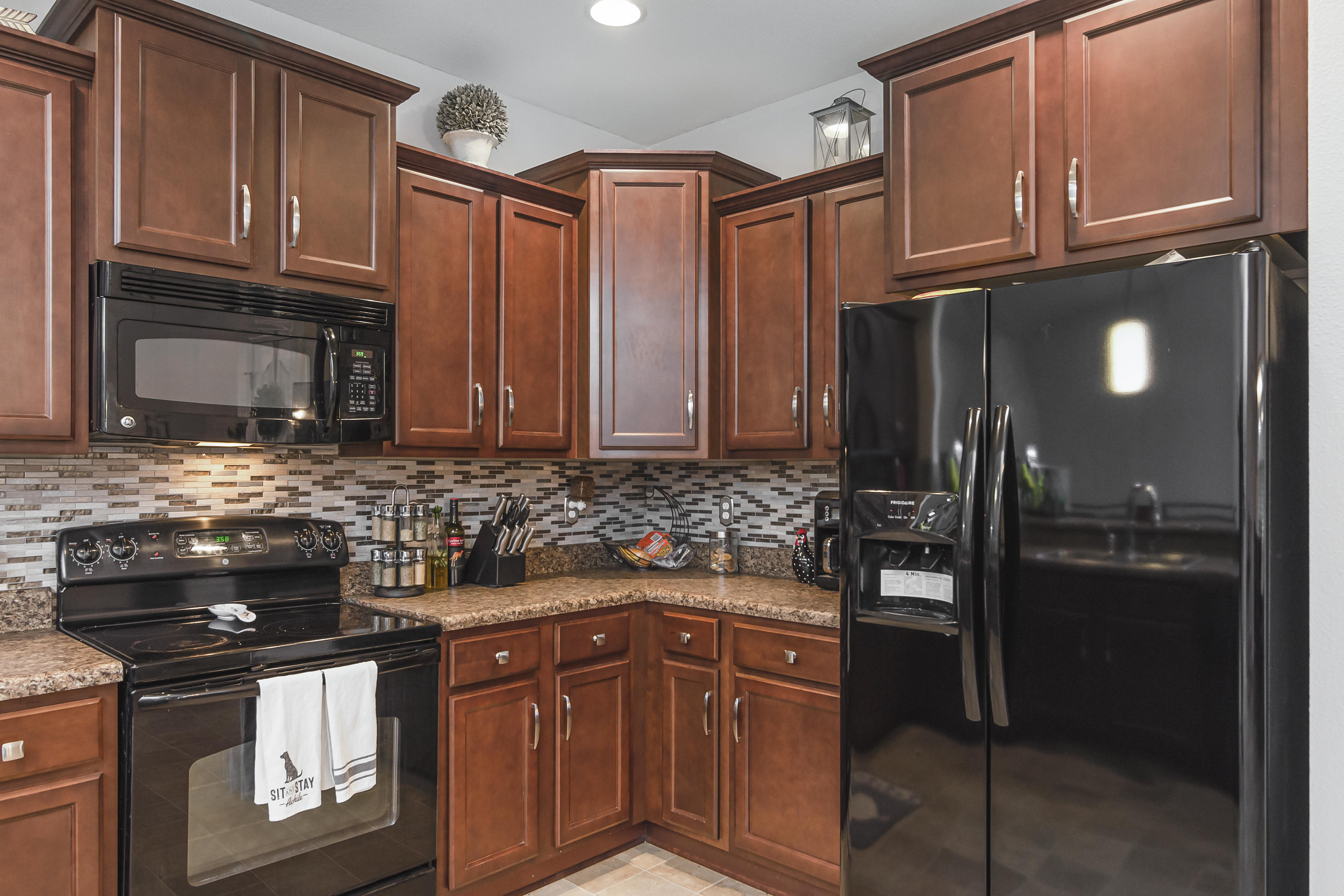 809 Yew Circle Crestview, FL 32536 - Photo 9 of 24 a kitchen with stainless steel appliances granite countertop a stove and a refrigerator