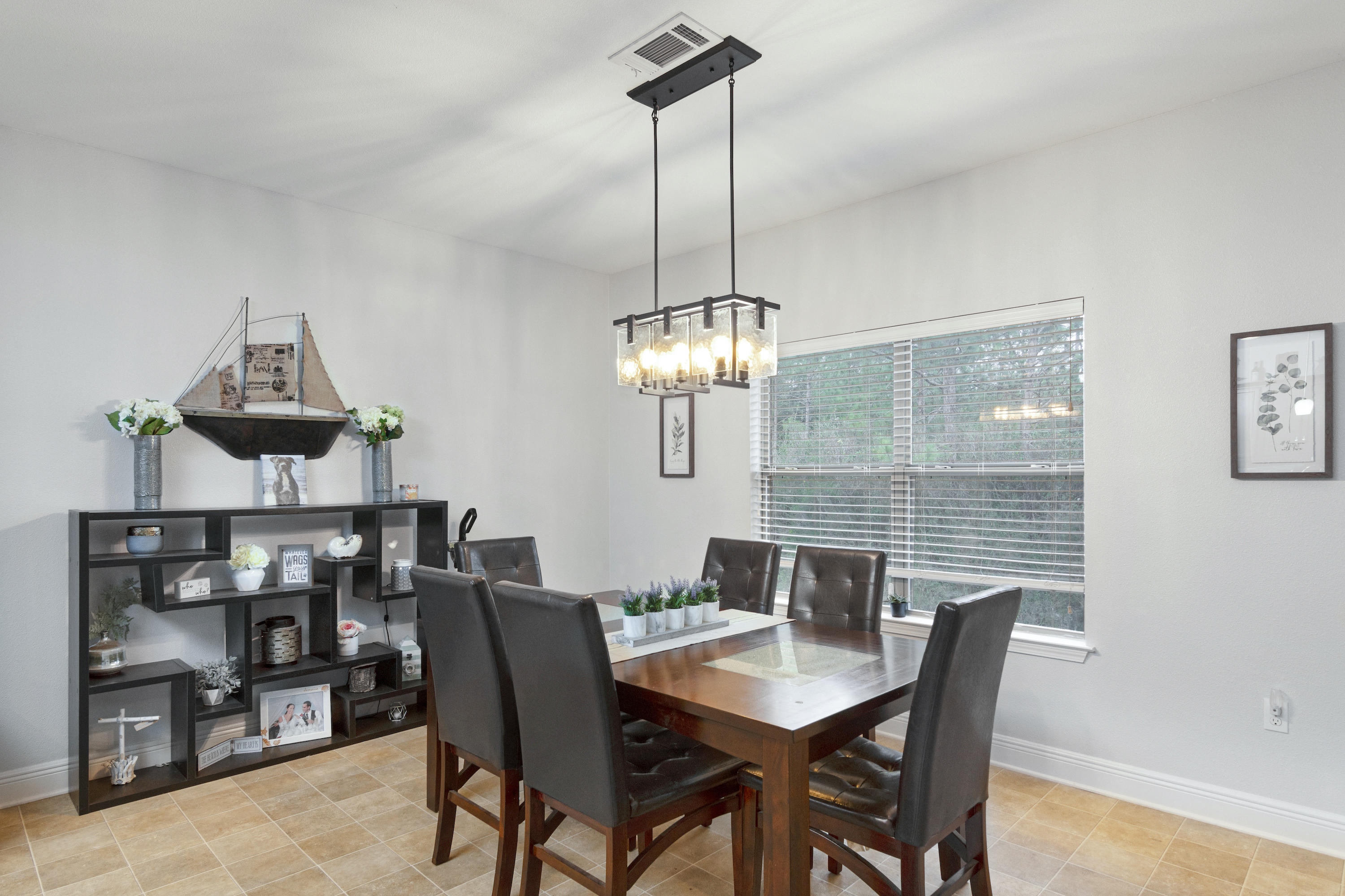 809 Yew Circle Crestview, FL 32536 - Photo 10 of 24 a view of a dining room with furniture a chandelier and wooden floor
