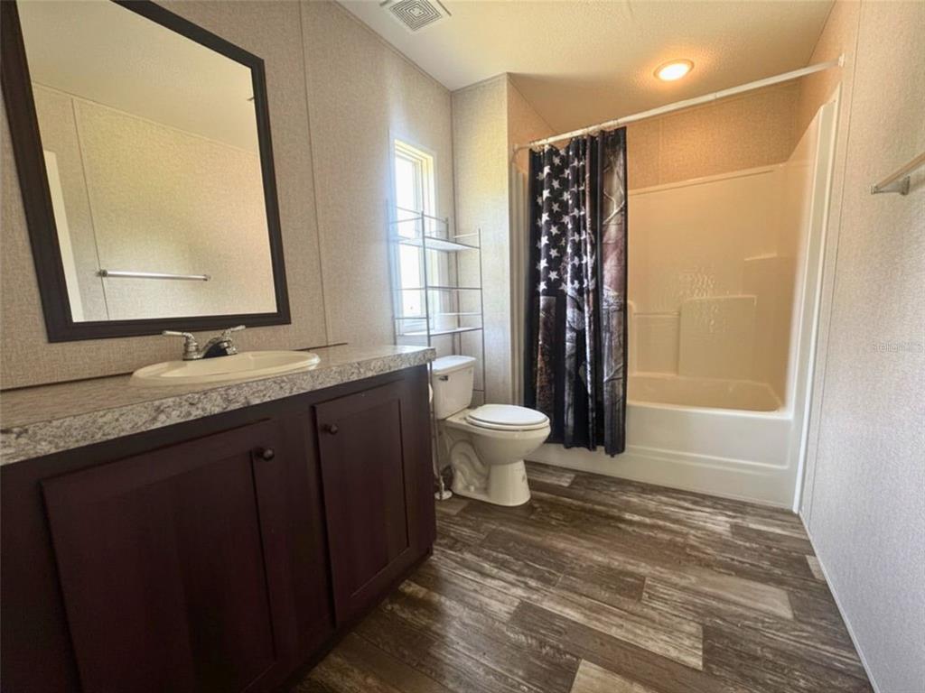 9827 Southeast Hoth Road Arcadia, FL 34266 - Photo 16 of 28 a bathroom with a granite countertop sink toilet and shower