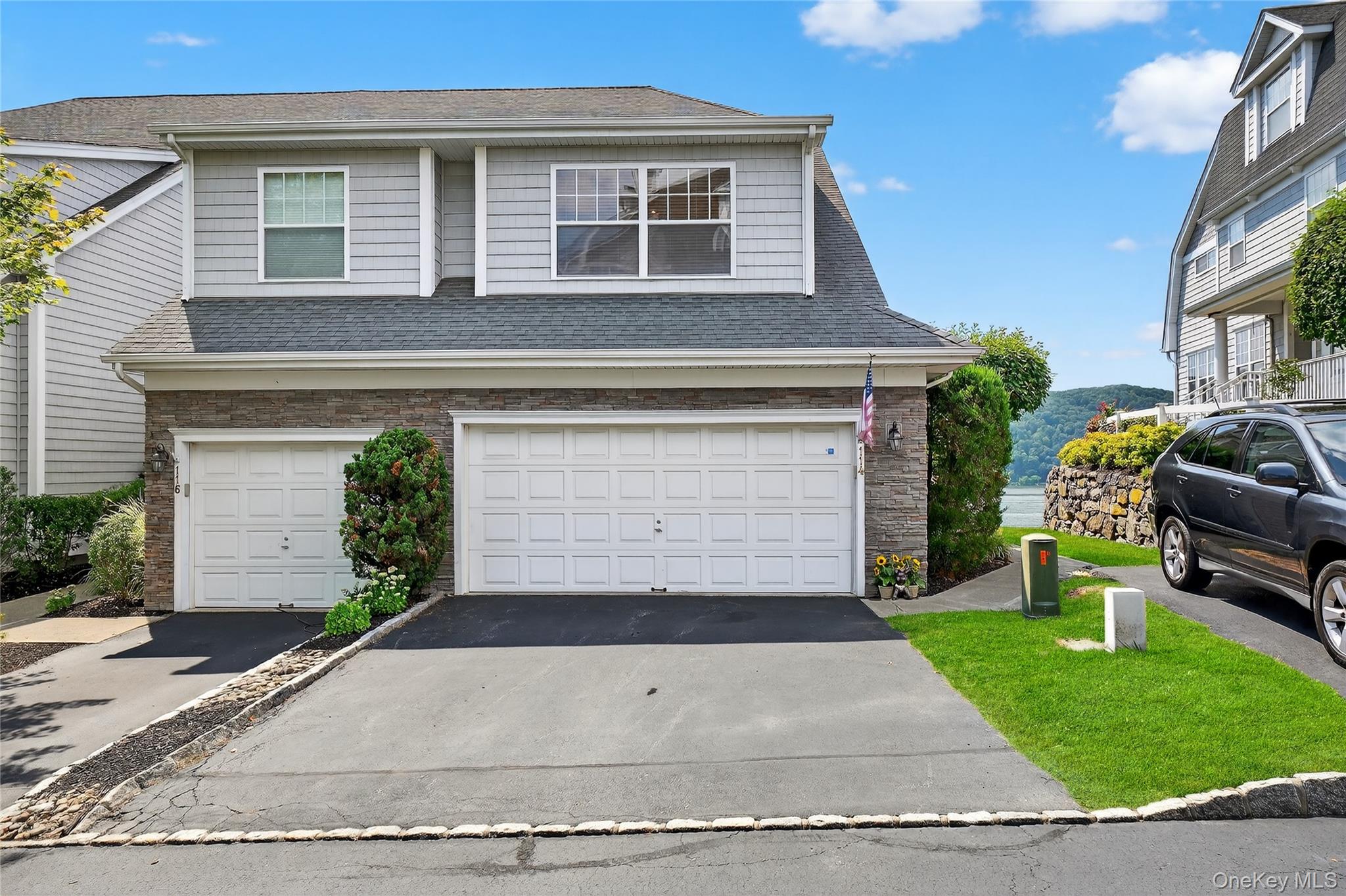 a front view of a house with a yard and garage