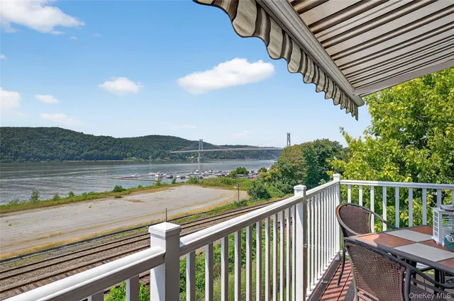 a balcony with wooden floor and outdoor space
