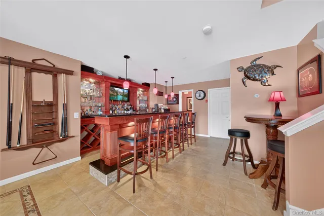 a dining room with furniture and floor to ceiling window