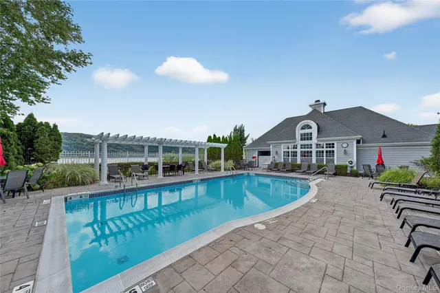 a front view of house with yard and lake view