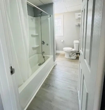 a bathroom with a tub and shower