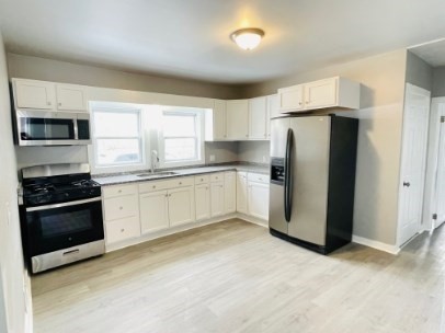 155 Oak Street, Unit 1 Taunton, MA 02780 - Photo 2 of 12 a kitchen with a refrigerator sink and stove top oven