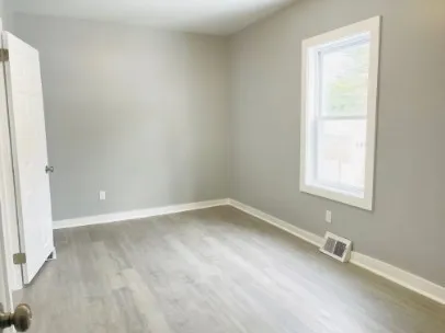 a view of an empty room with a window