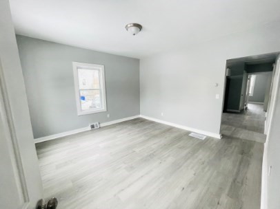 155 Oak Street, Unit 1 Taunton, MA 02780 - Photo 10 of 12 an empty room with wooden floor and windows
