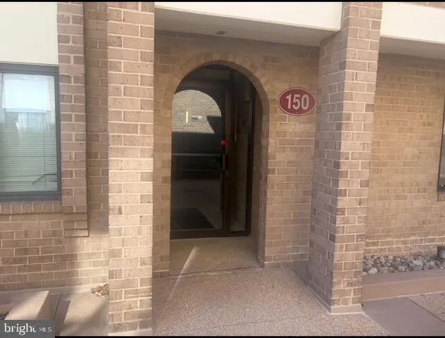 a view of room and hall with wooden floor