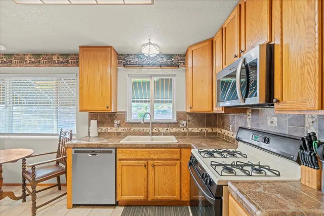 a kitchen with a sink appliances and cabinets