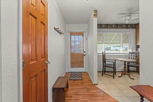 a view of a hallway with furniture and windows