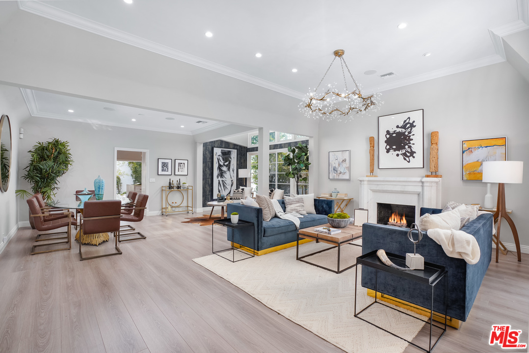 a living room with fireplace furniture and a chandelier