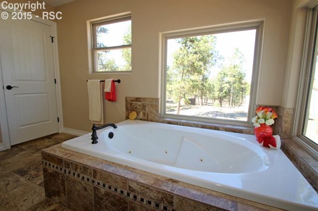 11420 Teachout Road Colorado Springs, CO 80908 - Photo 15 of 36 Soak in the master bath jetted tub while enjoying the outdoors.