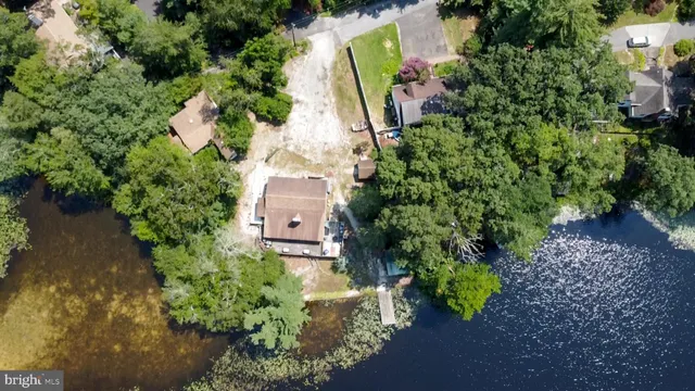 an aerial view of a house with a yard basket ball court and outdoor seating
