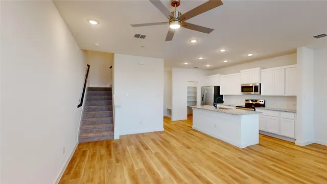 a view of kitchen with sink microwave and stove