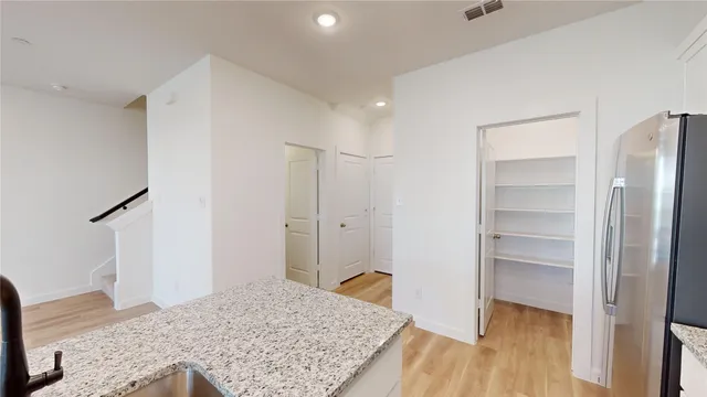 a view of a bedroom with wooden floor and closet