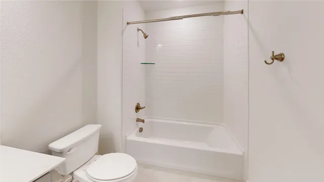 a bathroom with a toilet and shower