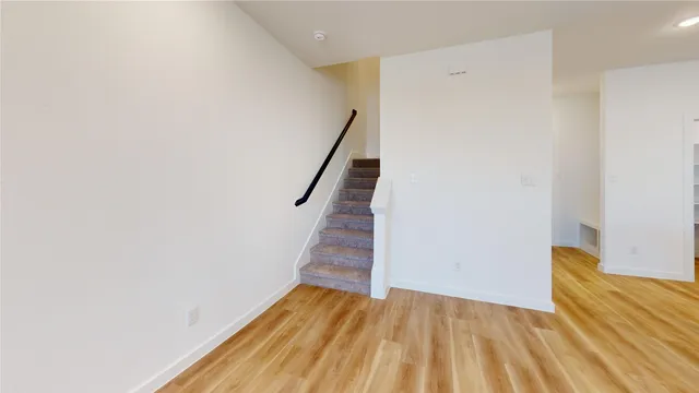 a view of a room with wooden floor and stairs