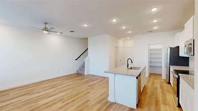 a view of a kitchen with refrigerator and a fireplace