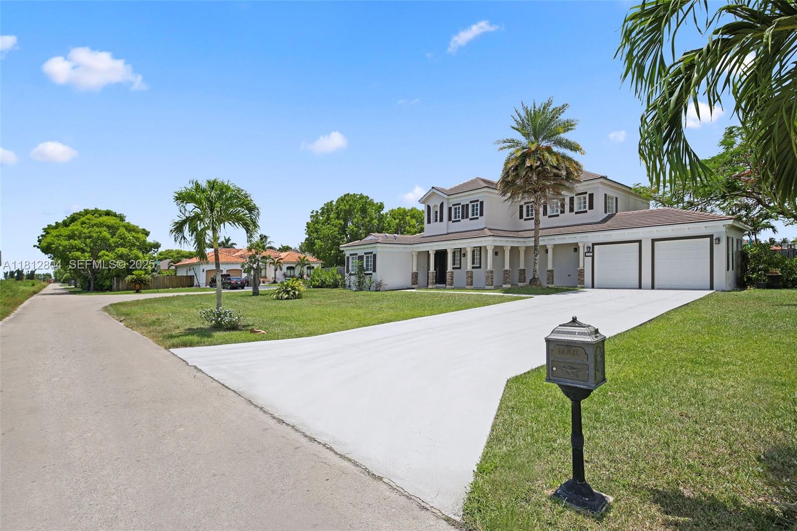 32360 Southwest 204th Avenue Homestead, FL 33030 - Photo 2 of 44 a front view of a house with a yard and potted plants