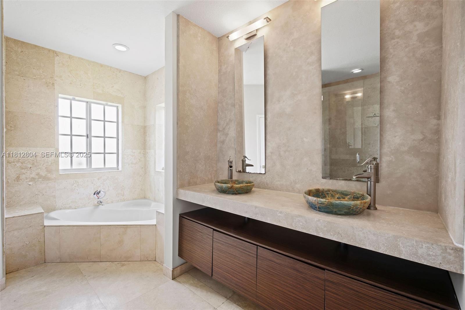 32360 Southwest 204th Avenue Homestead, FL 33030 - Photo 24 of 44 a bathroom with a double vanity sink large mirror and a bathtub