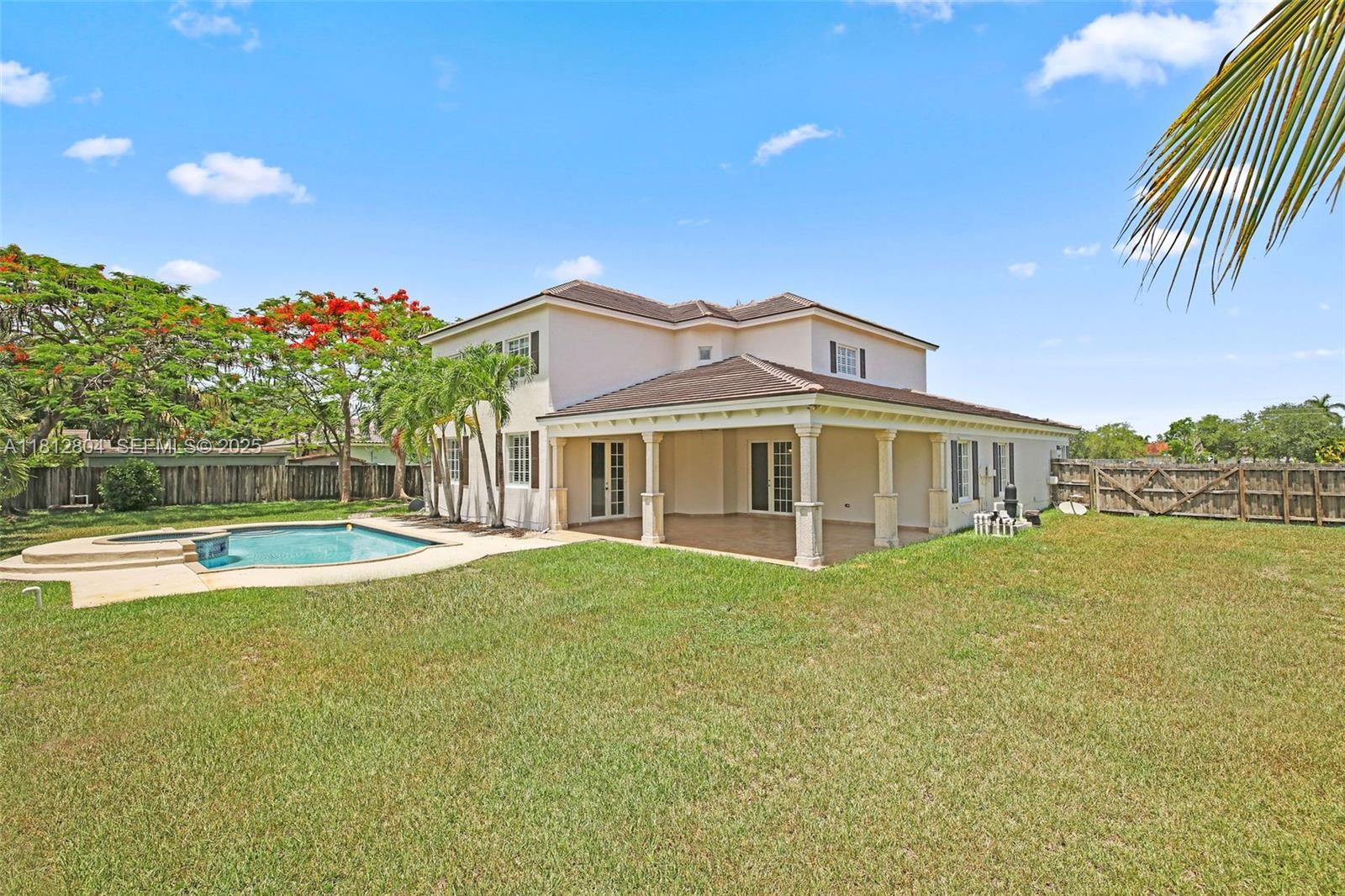 32360 Southwest 204th Avenue Homestead, FL 33030 - Photo 44 of 44 a view of a house with a swimming pool and a yard
