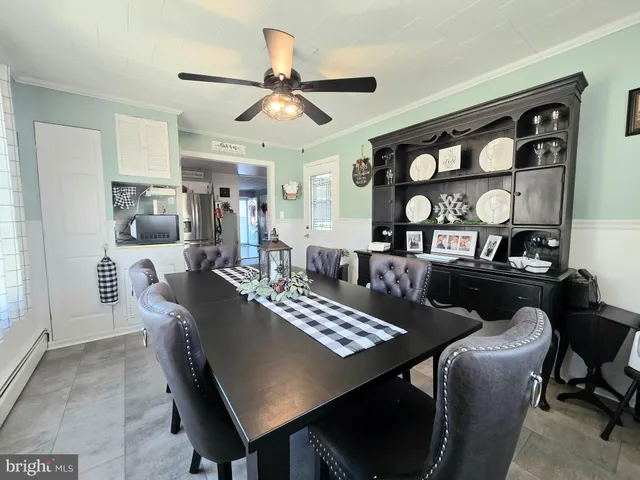a view of a a dining room with furniture window and wooden floor