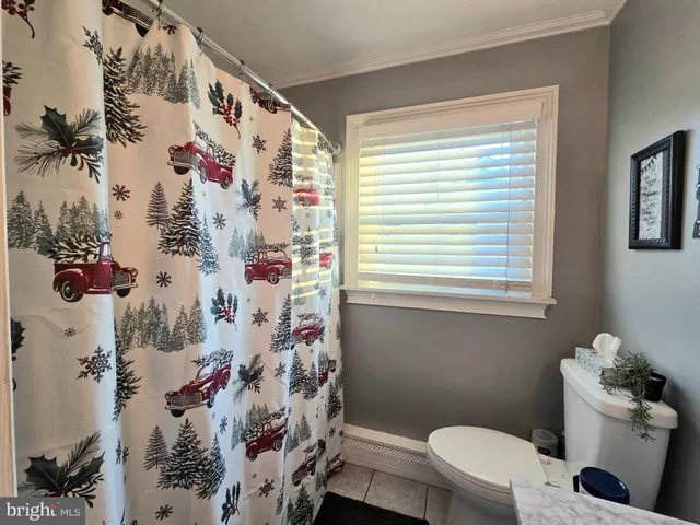 a bed room with a bed and a ceiling fan