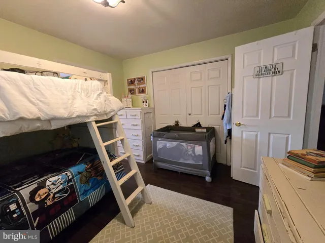 a bedroom with a bed and a tv on the dresser