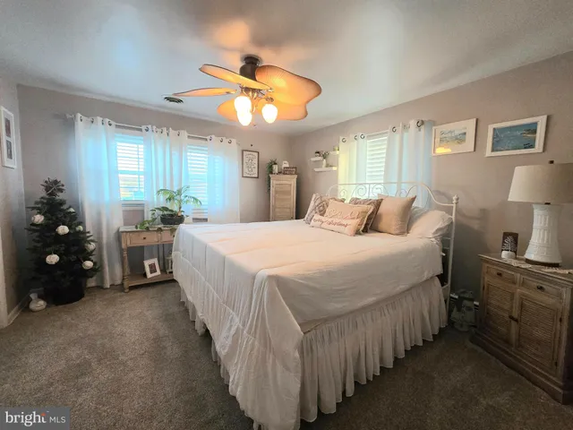 a white toilet sitting next to a bathroom sink and a tub
