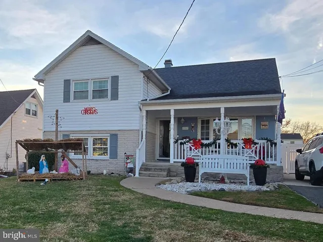 a front view of a house with a garden and porch