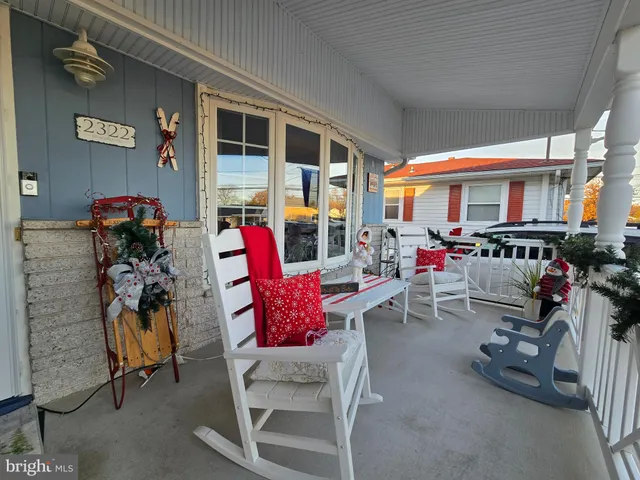 a living room with furniture a rug and white walls
