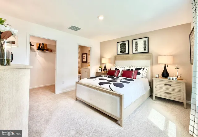 a view of a bedroom with a bed and a couch