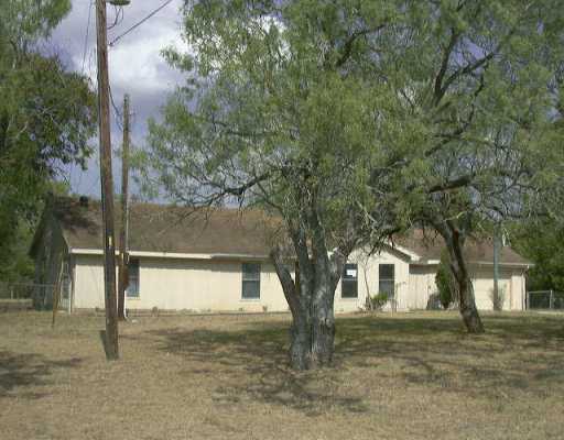 13401 Avis Road Dale, TX 78616 - Photo 1 of 1 a tree in front of a white house